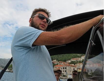 A person in sunglasses holding onto a boat